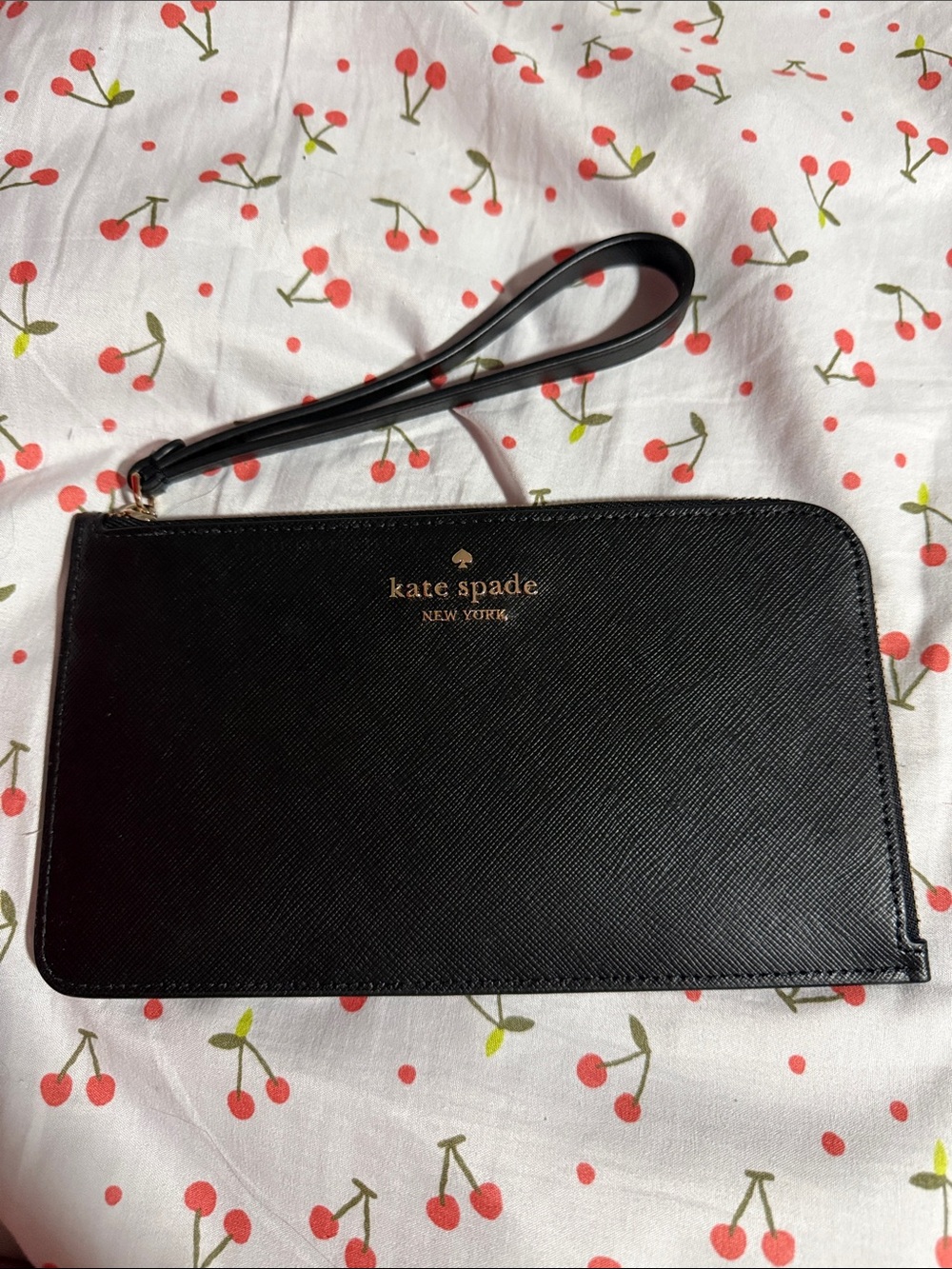 kate spade black leather wristlet with gold logo